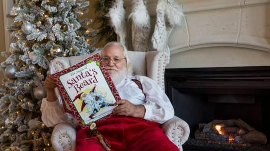Santa reading by the fireplace